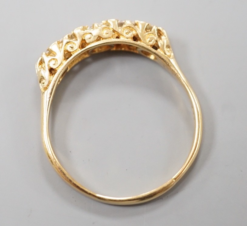A modern 18ct gold and graduated five stone diamond set half hoop ring, size T, gross weight 3.8 grams.